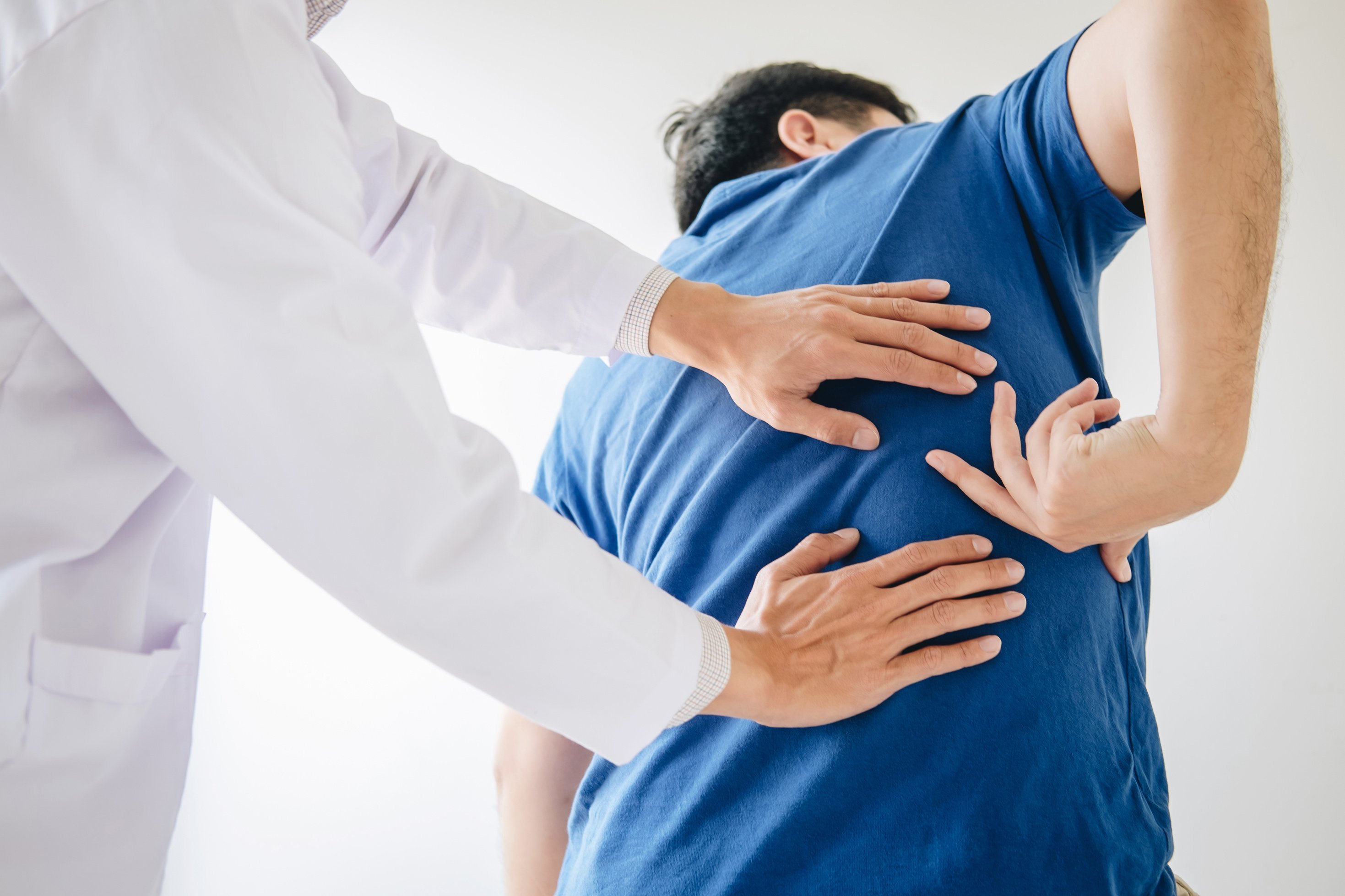 Physiotherapist Checking Patient's Lower Back Pain